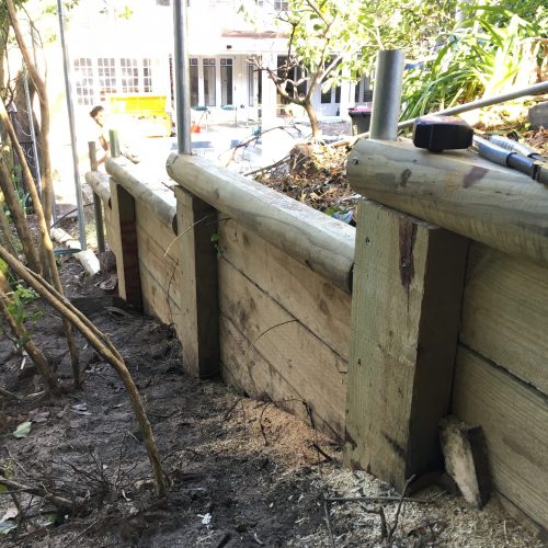 Purpose built retaining, securing the land on the high side of the fence and ensuring thatch will be elevated and protected from contact with the earth.